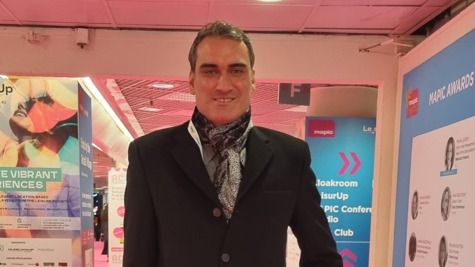 A man, Tolga Yuceturk, against a pink background represents Switch bowling